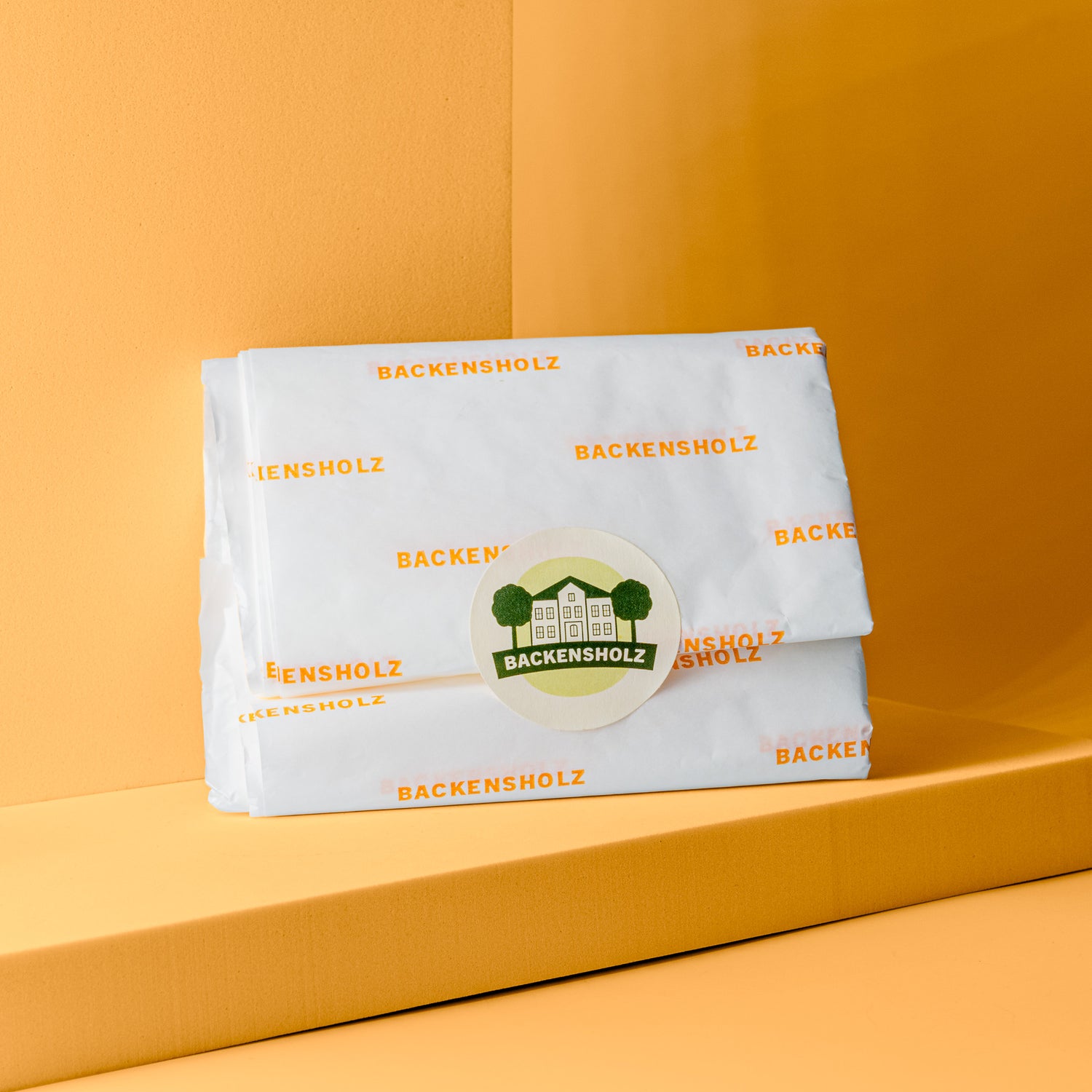 Backensholzer Käsepapier 20 Stück mit orangenem Schriftlogo.