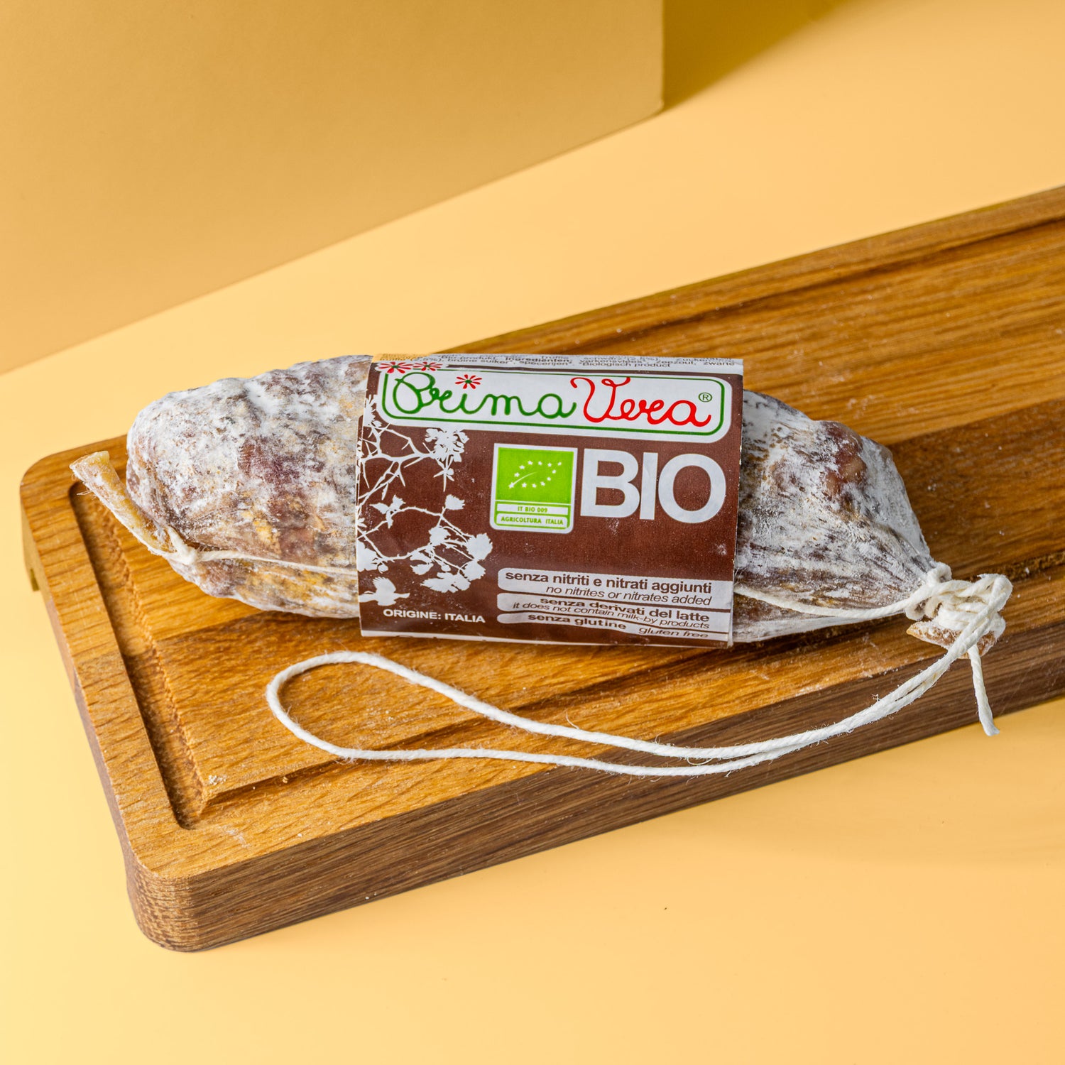 Trüffel Salami mit braun weißer Banderole auf Holzbrett.